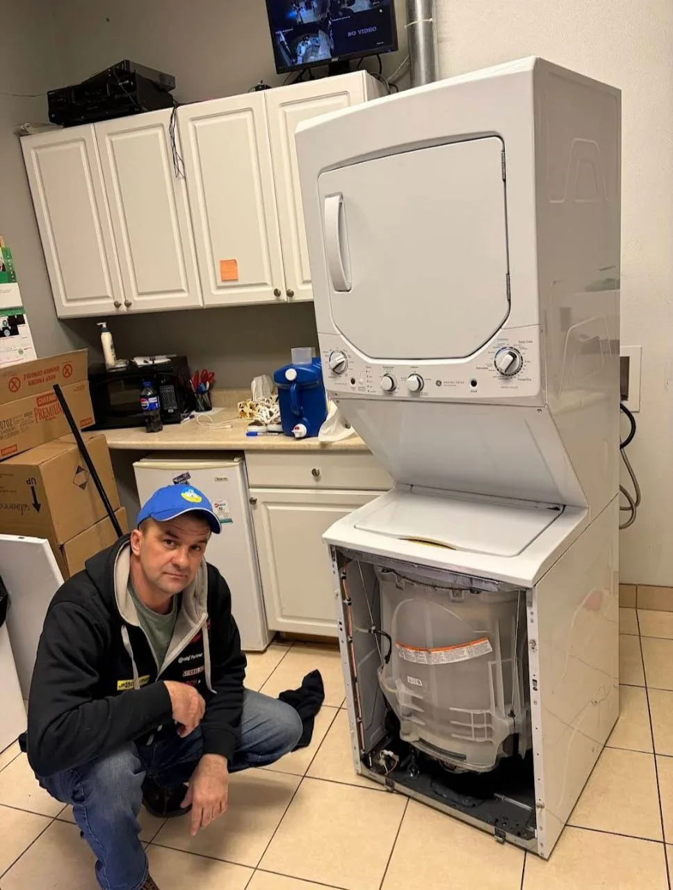 The washing machine repairman was repairing the washing machine. Reliable Appliance Repair in Cambridge, Ontario