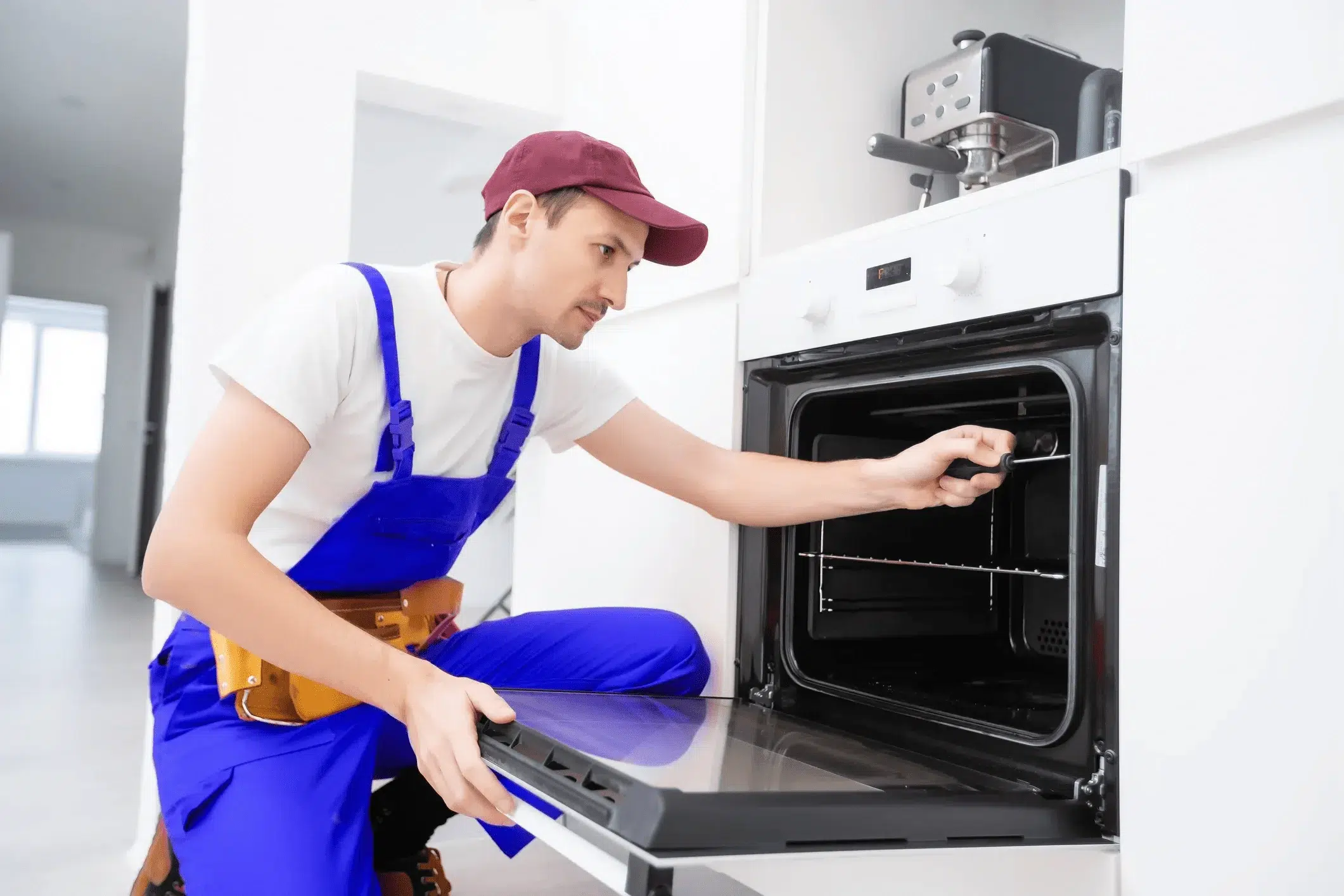 Home appliance repairman, repairing oven.