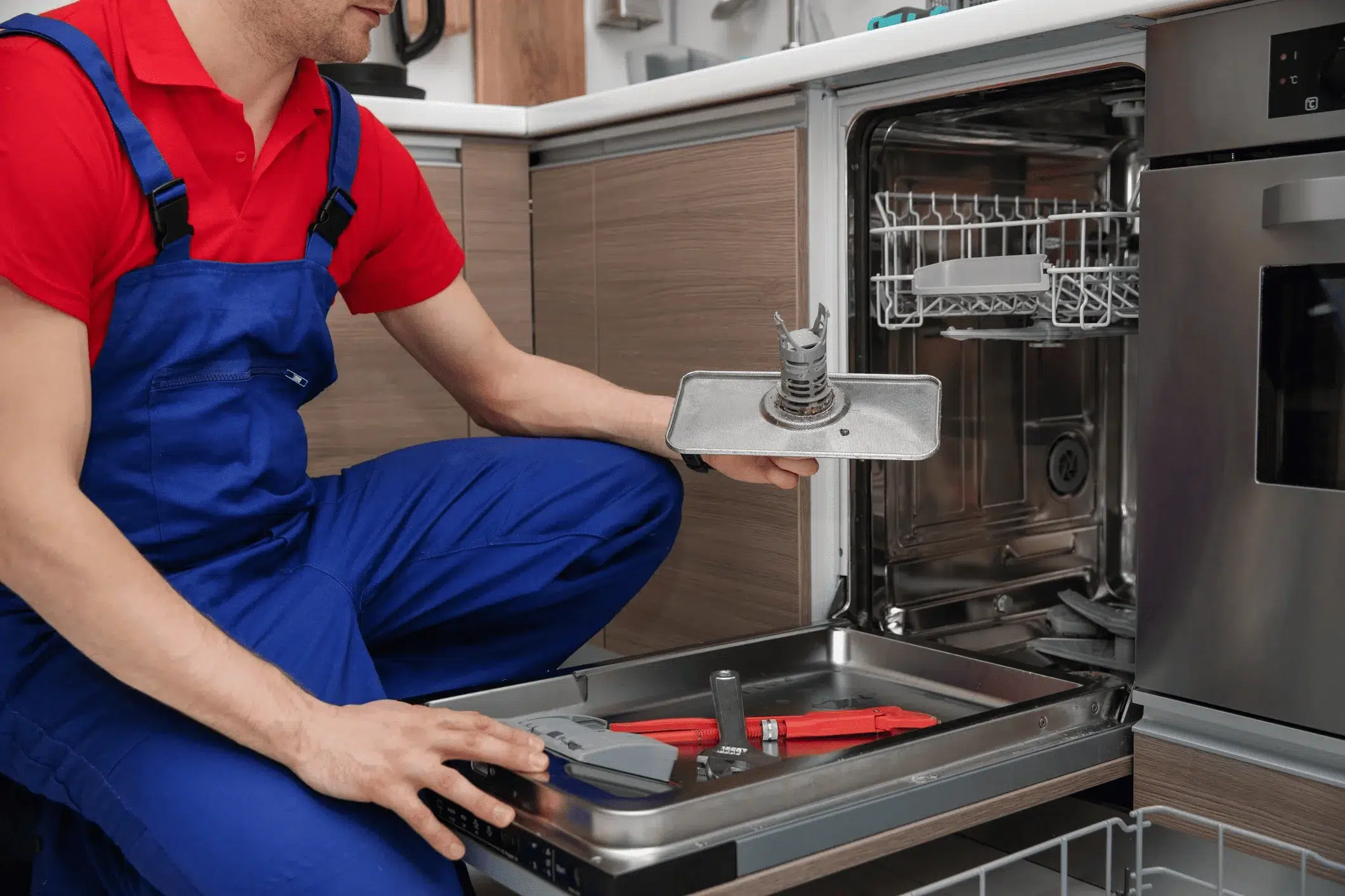 A home appliance repairman is repairing a dishwasher in Brantford